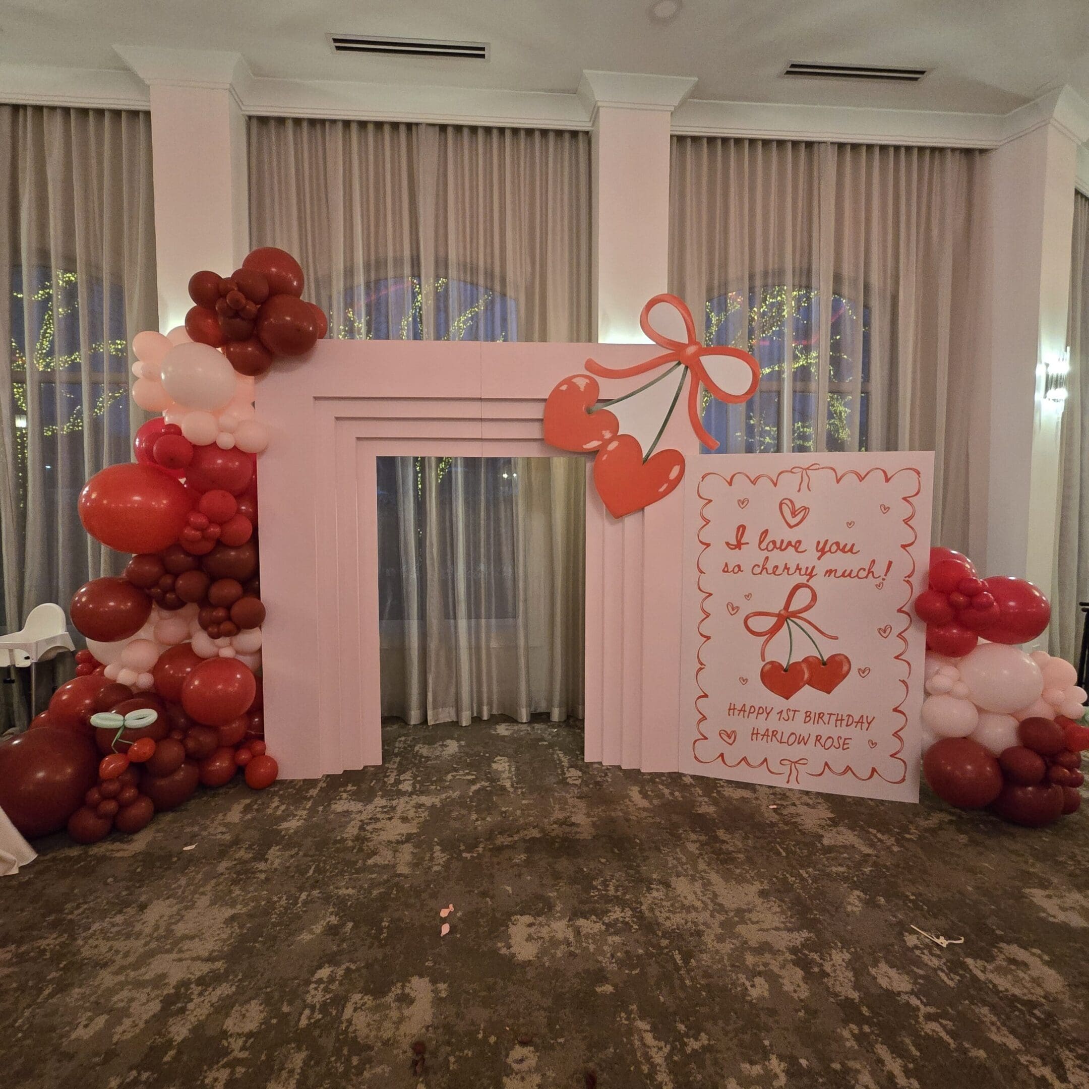 Decorative wedding backdrop with floral and heart accents.